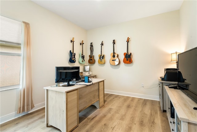 home office with light hardwood / wood-style floors