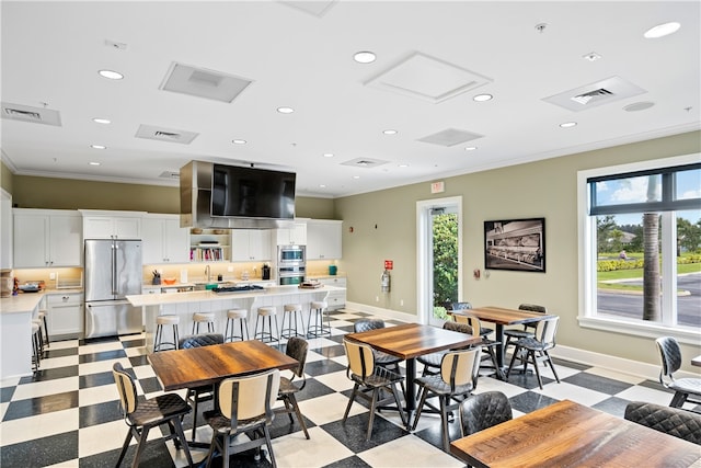 dining room with plenty of natural light and crown molding