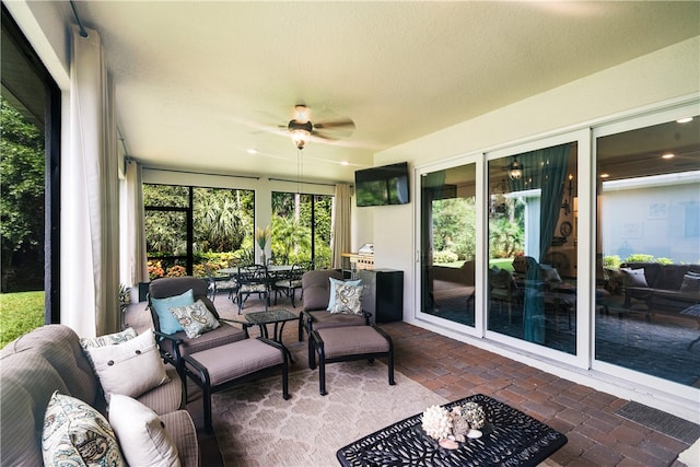 sunroom featuring ceiling fan and a healthy amount of sunlight