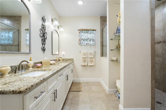 bathroom with vanity, tile patterned floors, and tiled shower