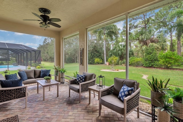 sunroom featuring ceiling fan