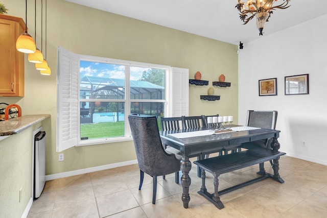 tiled dining area featuring a notable chandelier