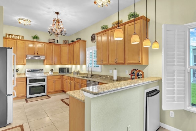 kitchen with appliances with stainless steel finishes, light stone countertops, hanging light fixtures, an inviting chandelier, and sink