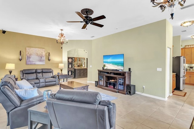 living room with ceiling fan with notable chandelier and light tile patterned flooring