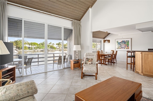 living room with light tile patterned floors, wooden ceiling, high vaulted ceiling, and a water view