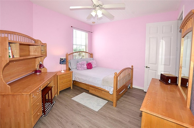 bedroom with light hardwood / wood-style flooring and ceiling fan