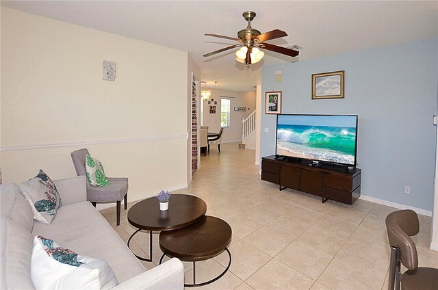 tiled living room featuring ceiling fan