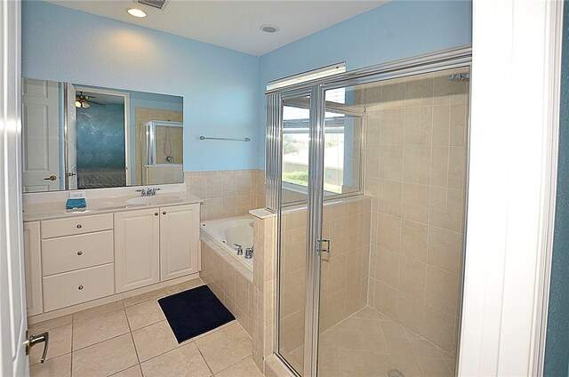 bathroom featuring vanity, independent shower and bath, ceiling fan, and tile patterned floors