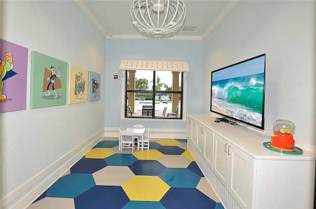 playroom with an inviting chandelier and crown molding