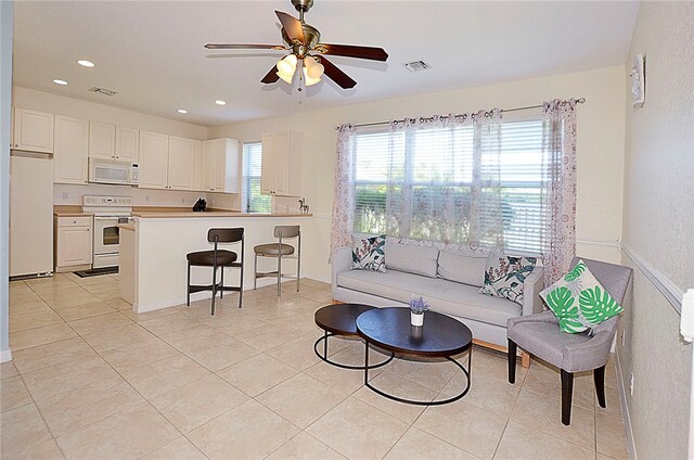 living room featuring ceiling fan and light tile patterned floors