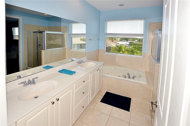 bathroom featuring vanity, independent shower and bath, and tile patterned floors