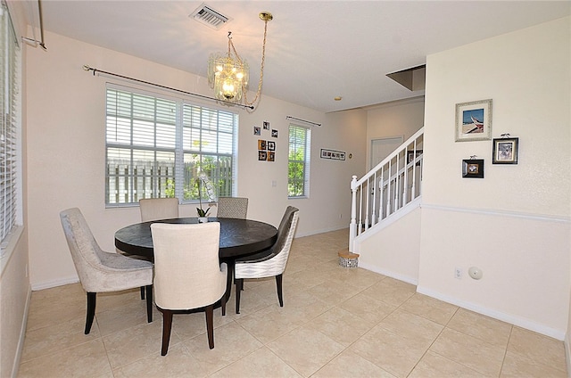 dining area featuring a wealth of natural light, an inviting chandelier, and light tile patterned floors