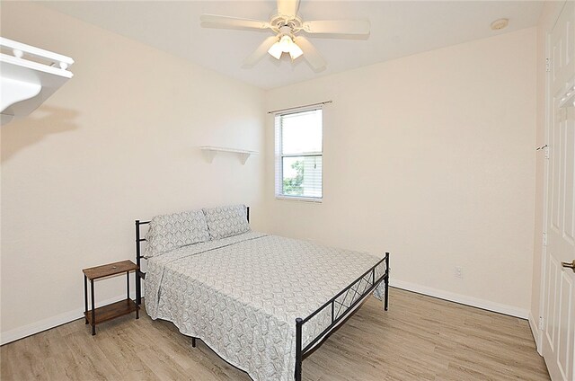 bedroom with ceiling fan and light hardwood / wood-style flooring