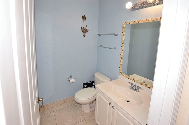 bathroom featuring toilet, vanity, and tile patterned floors