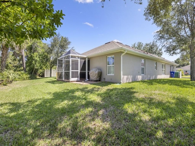 1206 Briarcliff Ct, Sebastian, FL 32958 - back of property with stucco siding, a lawn, and glass enclosure