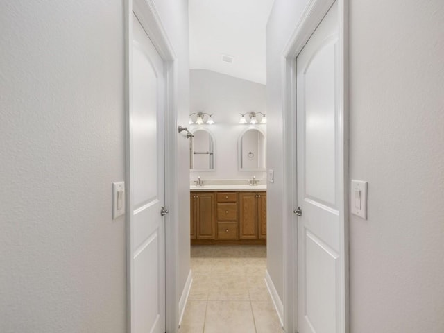 1206 Briarcliff Ct, Sebastian, FL 32958 - full bath with lofted ceiling, double vanity, tile patterned flooring, and baseboards