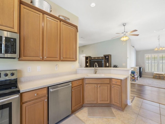 1206 Briarcliff Ct, Sebastian, FL 32958 - kitchen featuring stainless steel appliances, a sink, a peninsula, lofted ceiling, and light countertops