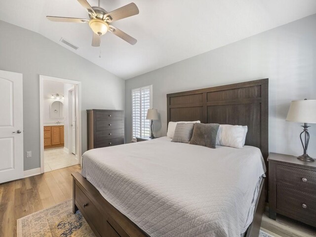 1206 Briarcliff Ct, Sebastian, FL 32958 - bedroom with vaulted ceiling, light wood-type flooring, ensuite bath, a ceiling fan, and baseboards