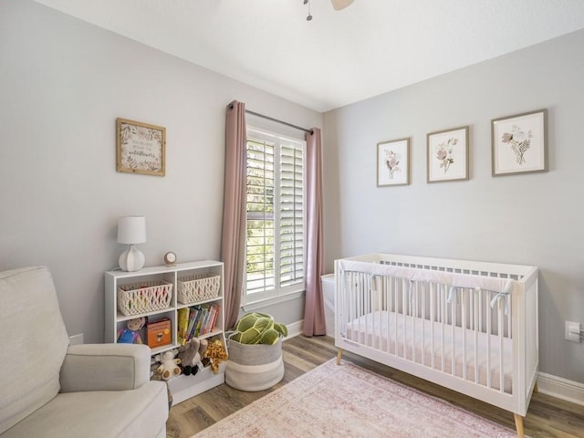 1206 Briarcliff Ct, Sebastian, FL 32958 - bedroom with wood finished floors, a crib, and baseboards