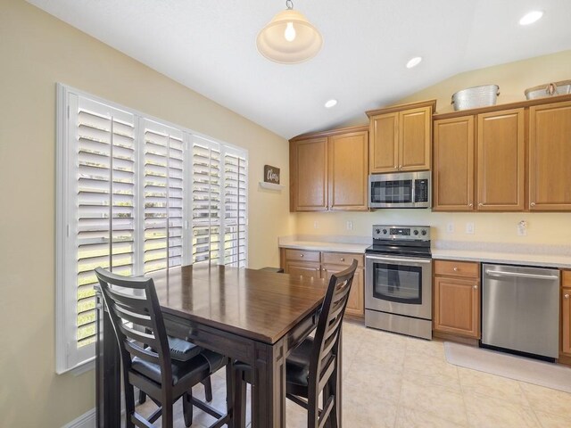 1206 Briarcliff Ct, Sebastian, FL 32958 - kitchen with stainless steel appliances, lofted ceiling, light countertops, plenty of natural light, and light tile patterned floors