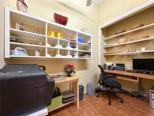 home office with baseboards and wood finished floors