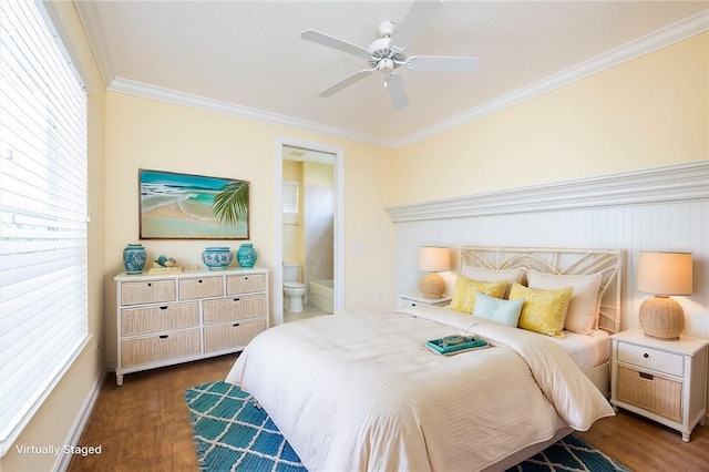 bedroom with ceiling fan, connected bathroom, dark wood finished floors, and crown molding