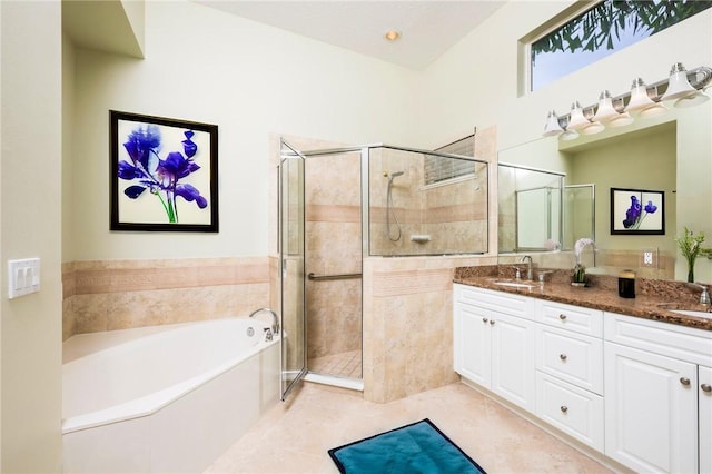 bathroom featuring double vanity, a garden tub, tile patterned flooring, a shower stall, and a sink