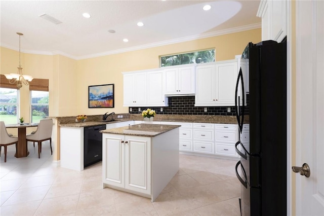 kitchen with a kitchen island, dark stone countertops, black appliances, white cabinetry, and pendant lighting