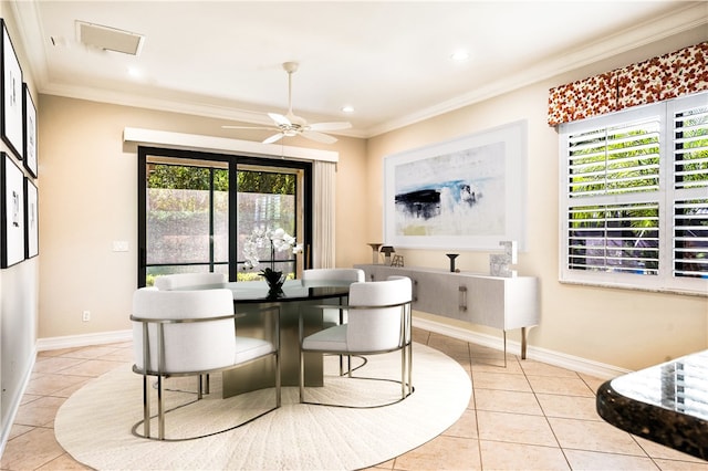 tiled dining area featuring ceiling fan, a wealth of natural light, and ornamental molding