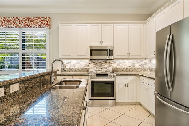 kitchen with white cabinets, dark stone counters, sink, and appliances with stainless steel finishes