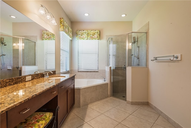 bathroom with independent shower and bath, vanity, and tile patterned flooring