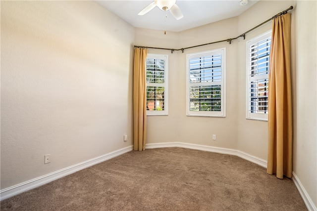 unfurnished room featuring ceiling fan and carpet