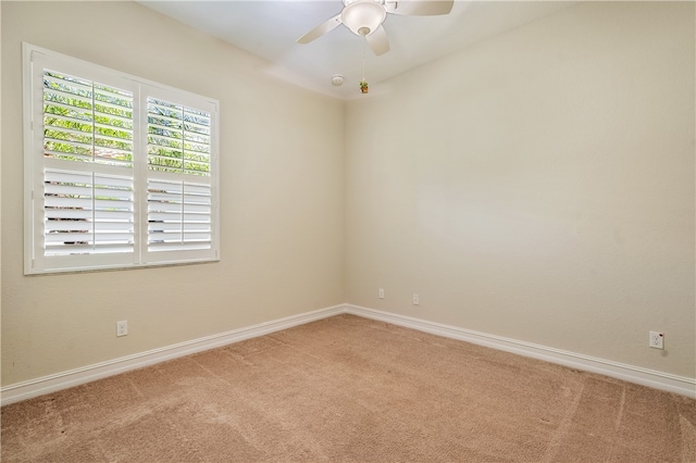 carpeted spare room with ceiling fan