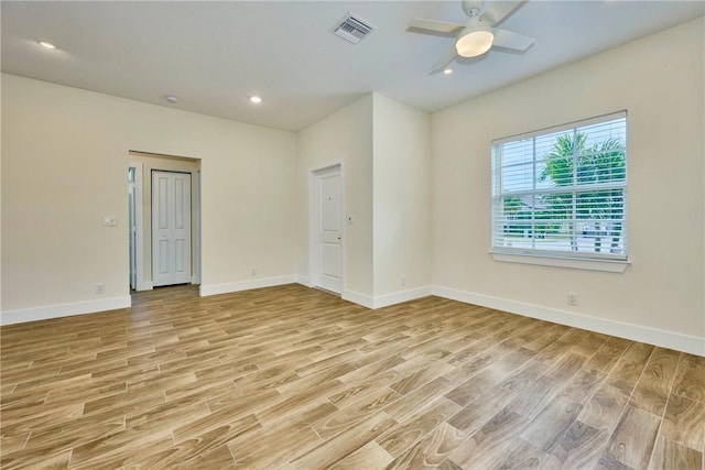 unfurnished room with ceiling fan and light wood-type flooring