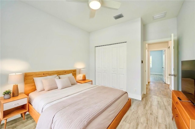 bedroom with light hardwood / wood-style floors, a closet, and ceiling fan