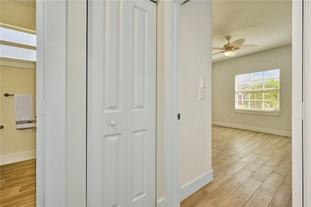 hallway with light hardwood / wood-style floors