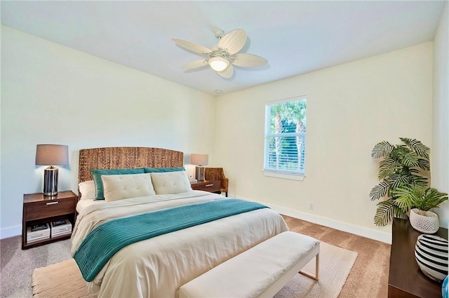 bedroom with ceiling fan and light carpet