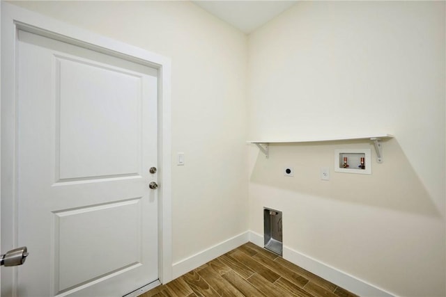 clothes washing area with electric dryer hookup, washer hookup, and dark hardwood / wood-style flooring