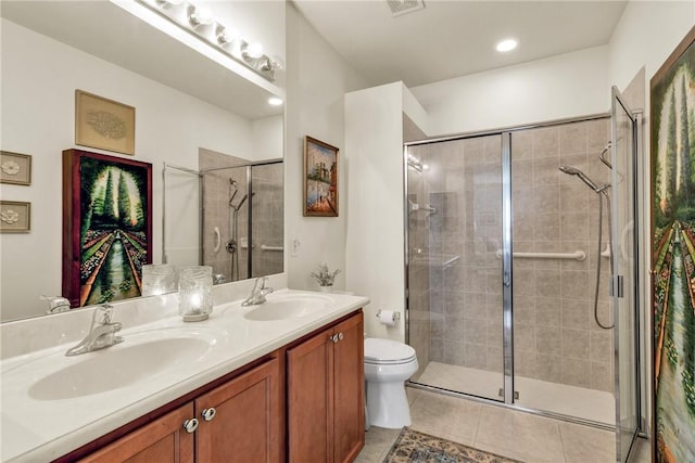 bathroom with a shower with door, tile patterned floors, toilet, and vanity