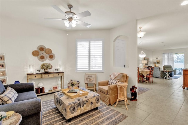 living room featuring ceiling fan, light tile patterned floors, and plenty of natural light