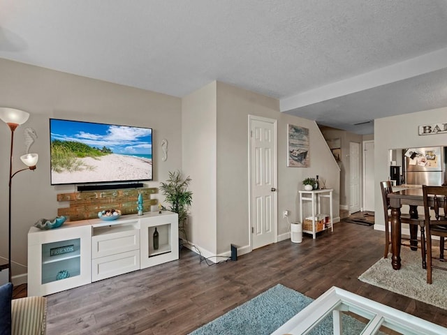 1901 Indian River Blvd Unit 201A, Vero Beach, FL 32960 - bar featuring dark wood-style flooring, freestanding refrigerator, baseboards, and a textured ceiling