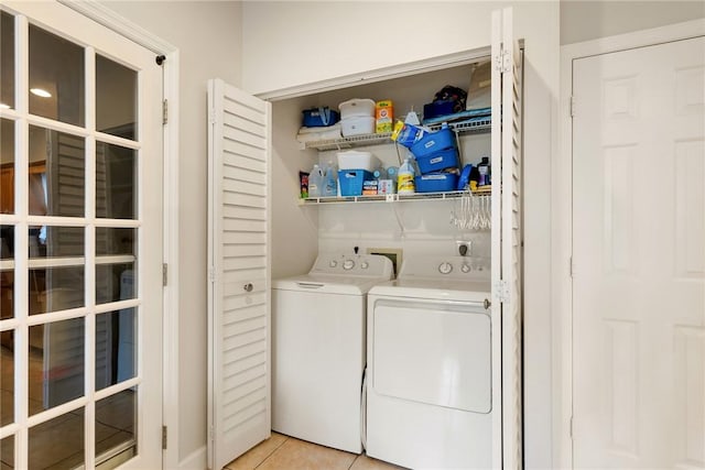 laundry area featuring light tile patterned flooring and separate washer and dryer