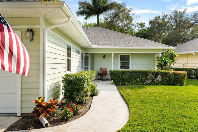 doorway to property with a yard