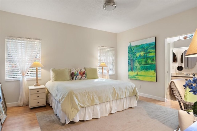 bedroom featuring light hardwood / wood-style floors and multiple windows