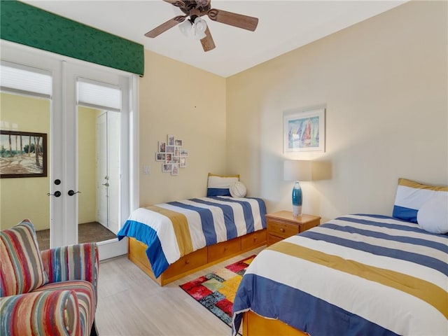 bedroom featuring ceiling fan, light hardwood / wood-style floors, and french doors