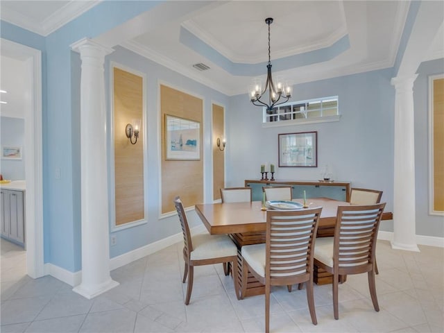 dining space with crown molding, light tile patterned floors, a tray ceiling, and ornate columns