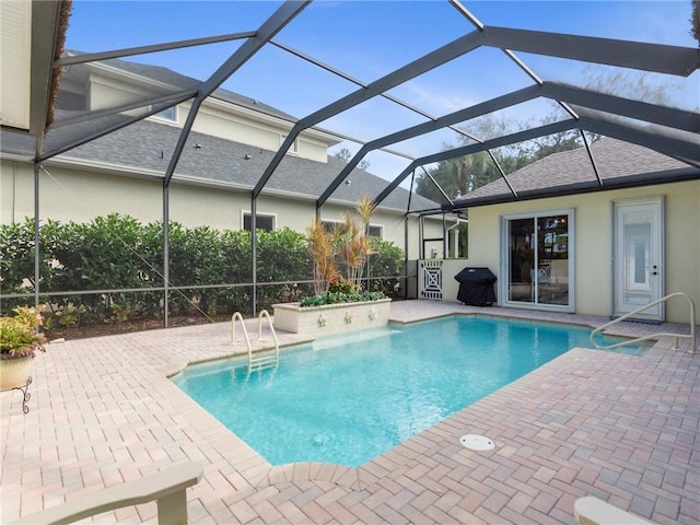 view of pool featuring a grill, a lanai, and a patio