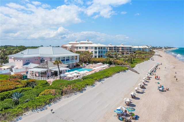 birds eye view of property with a beach view and a water view