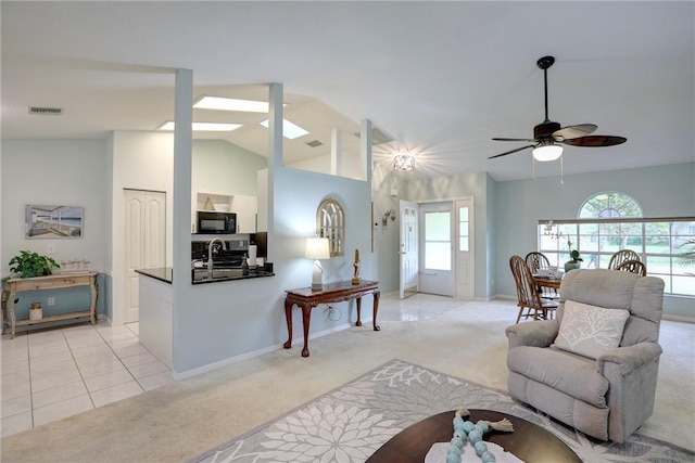 907 Starflower Ave, Sebastian, FL 32958 - living room featuring light colored carpet, lofted ceiling, a ceiling fan, and healthy amount of natural light