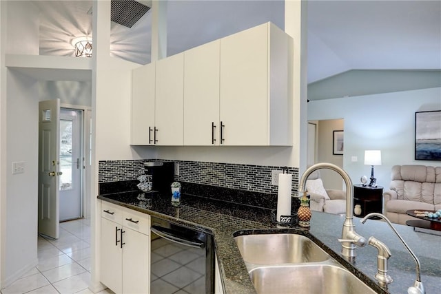 907 Starflower Ave, Sebastian, FL 32958 - kitchen featuring dishwasher, open floor plan, tasteful backsplash, dark stone countertops, and lofted ceiling